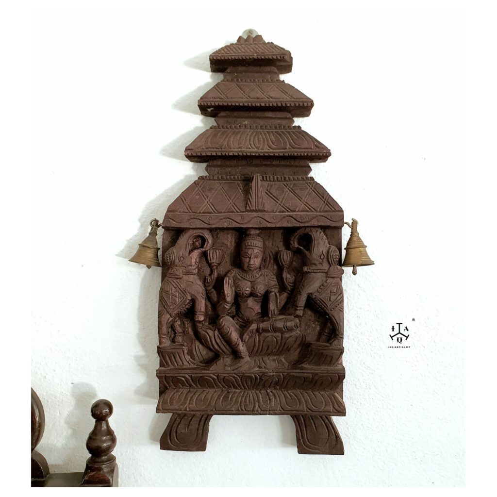 Kaavadi carved wood panel features Gajalakshmi